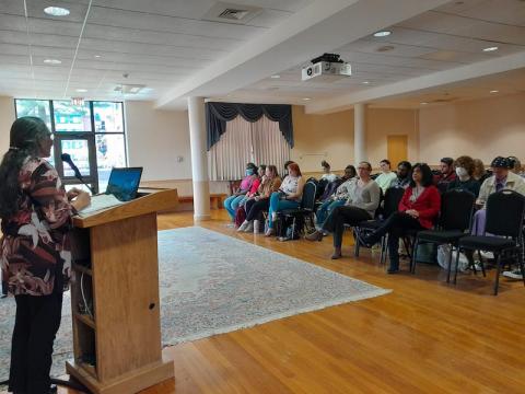 Dr. Venkateswaran stands before a pulpit and addresses a crowd of student and faculty members.