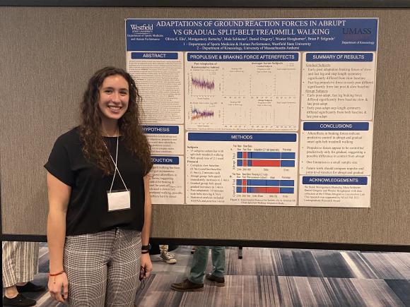 Photo of female student in front of presentation board