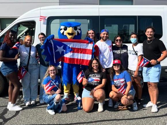 Westfield State students pose with the mascot Nestor at the Puerto Rican Day parade in Springfield MA