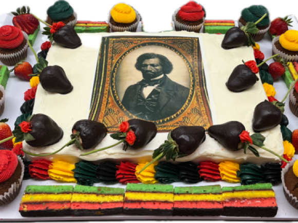 A Douglass Day cake decorated with an image of him on the frosting, along with colorful accents for Douglass Day.