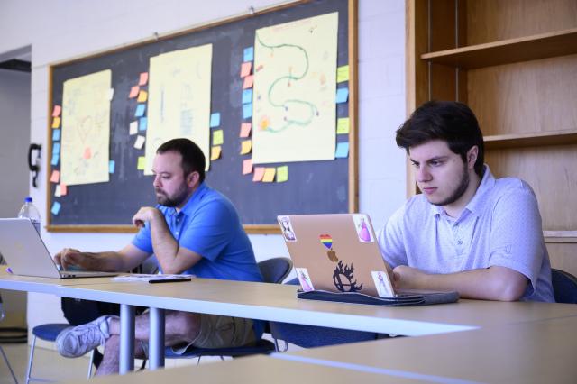 Western Mass Writing Project two students with laptops focused on projects