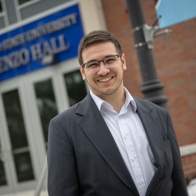 Student smiling outside of Parenzo Hall.