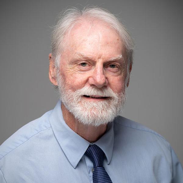 Glen Brewster, Chair of the English Department at Westfield State University, smiles for a professional photo.