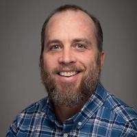 James McNamara, Chair of the Theatre Arts Department at Westfield State University, smiles for a posed professional photo.